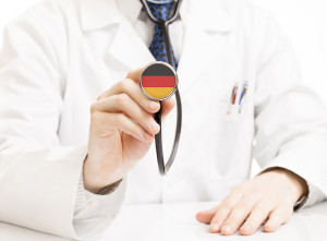 Doctor holding stethoscope with flag series - Germany